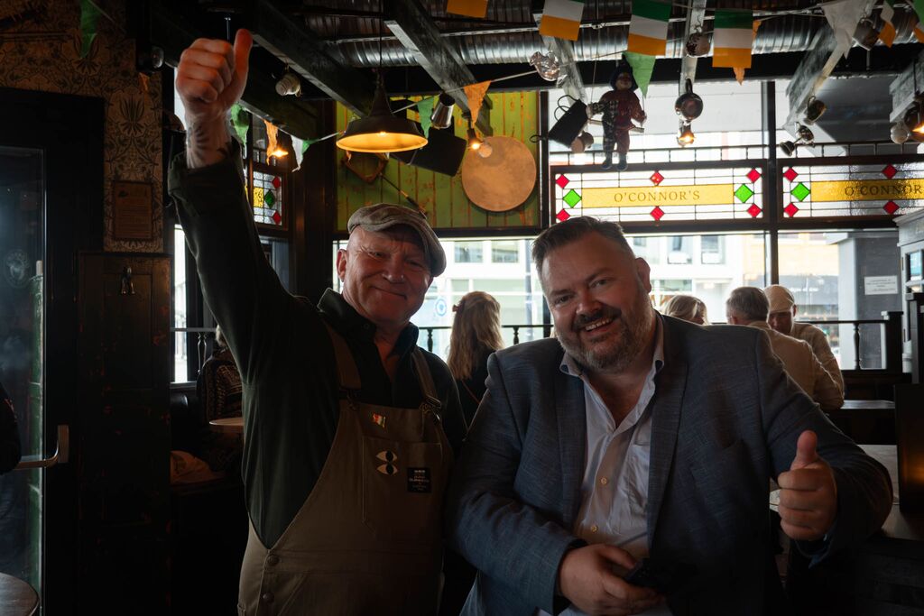 Bilde av to menn som smiler inne på Oconnors Harstad.